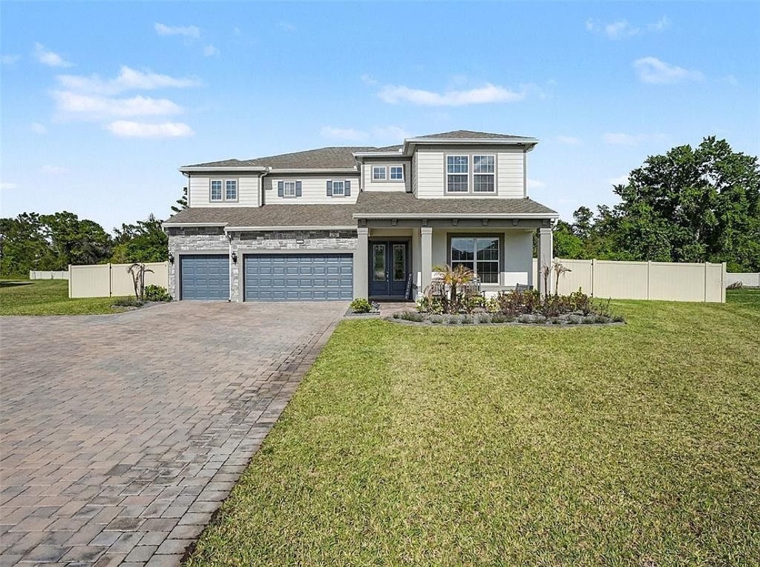 4389 Sunset Preserve Blvd, a two-story house built in 2024 with a three-car garage and wide paver driveway
